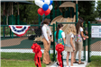 girl scout members opening park gate 