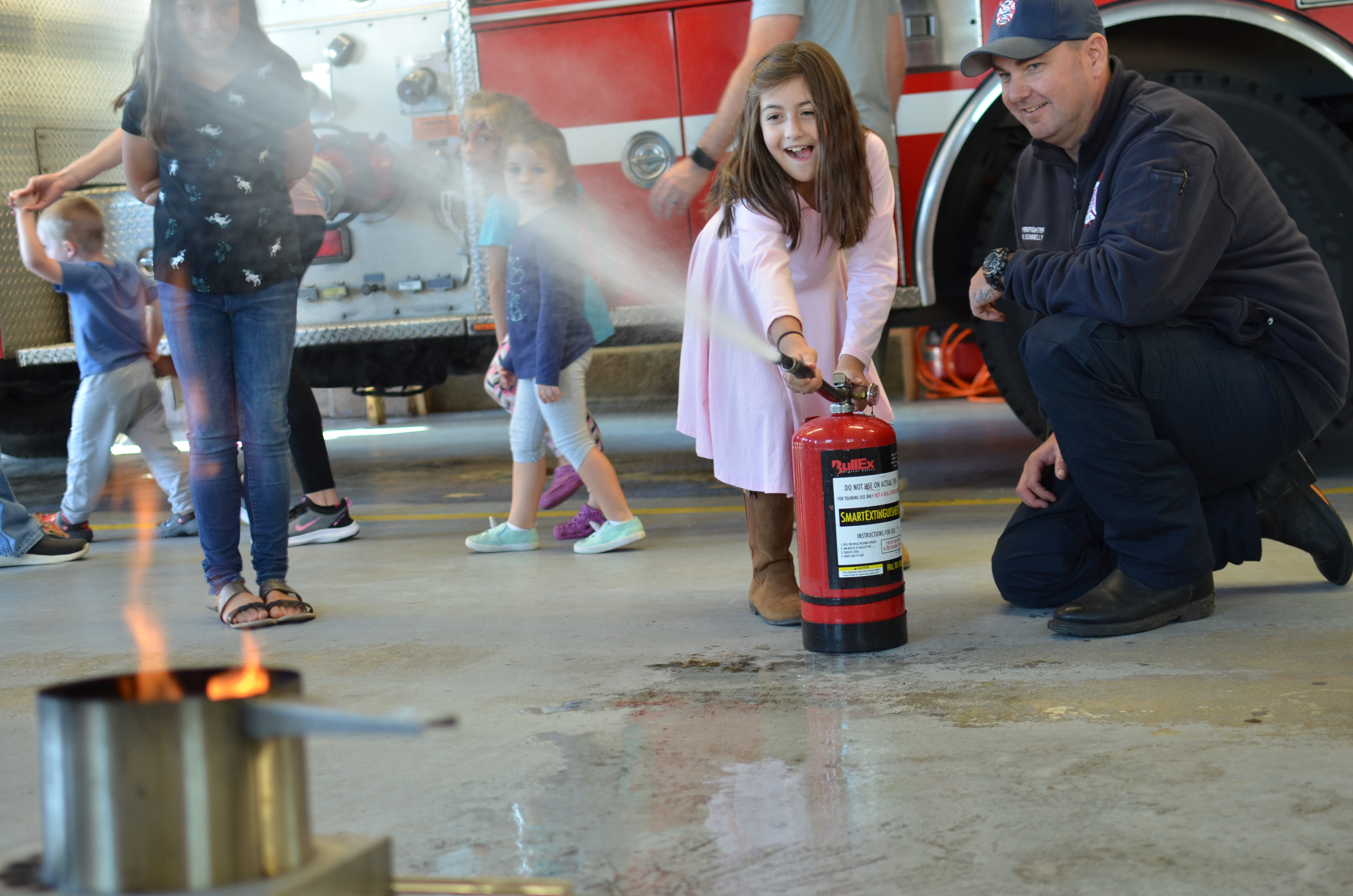 firefighter demonstrates use of fire extinguisher