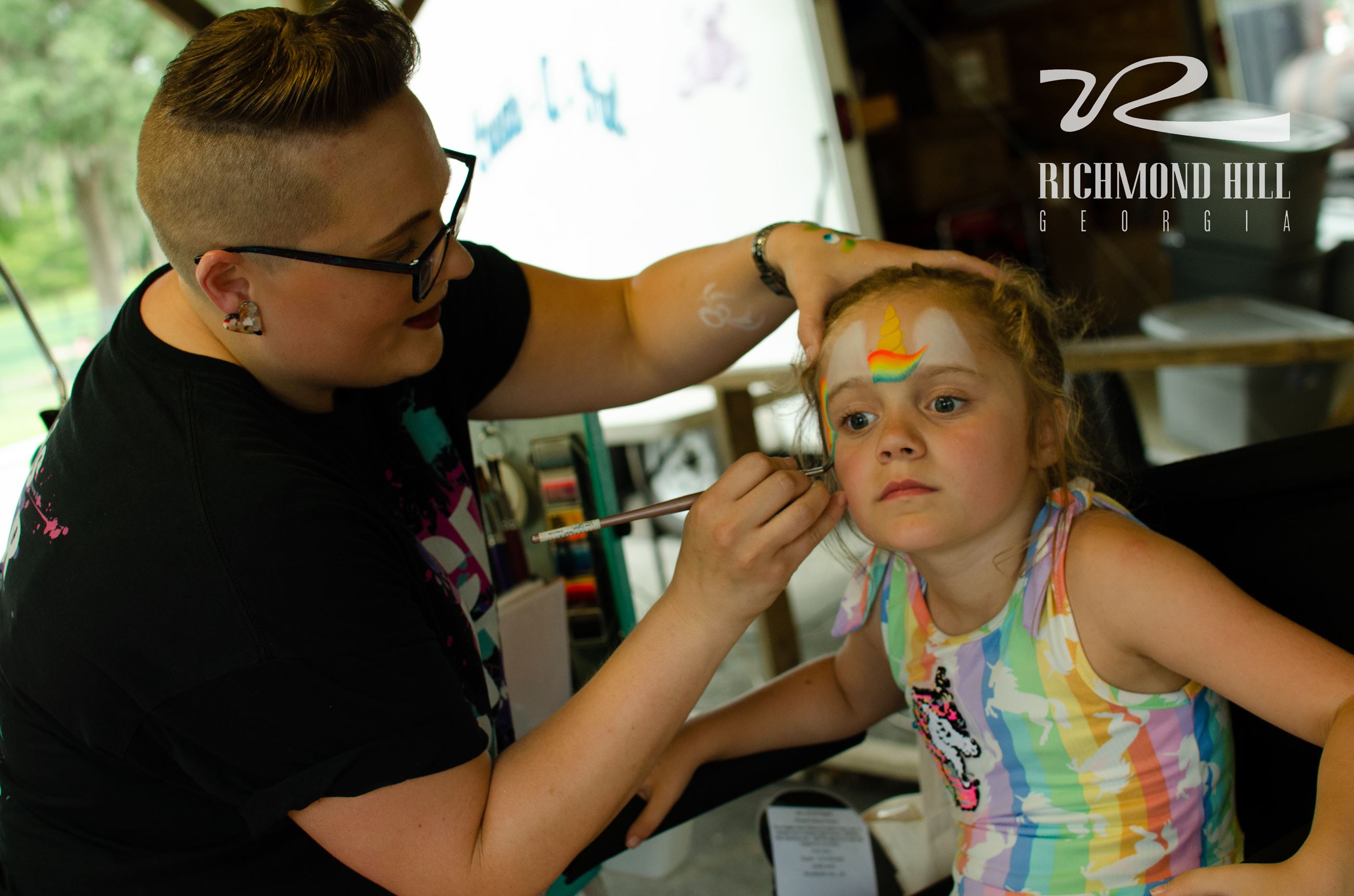 girl sitting at face painting station