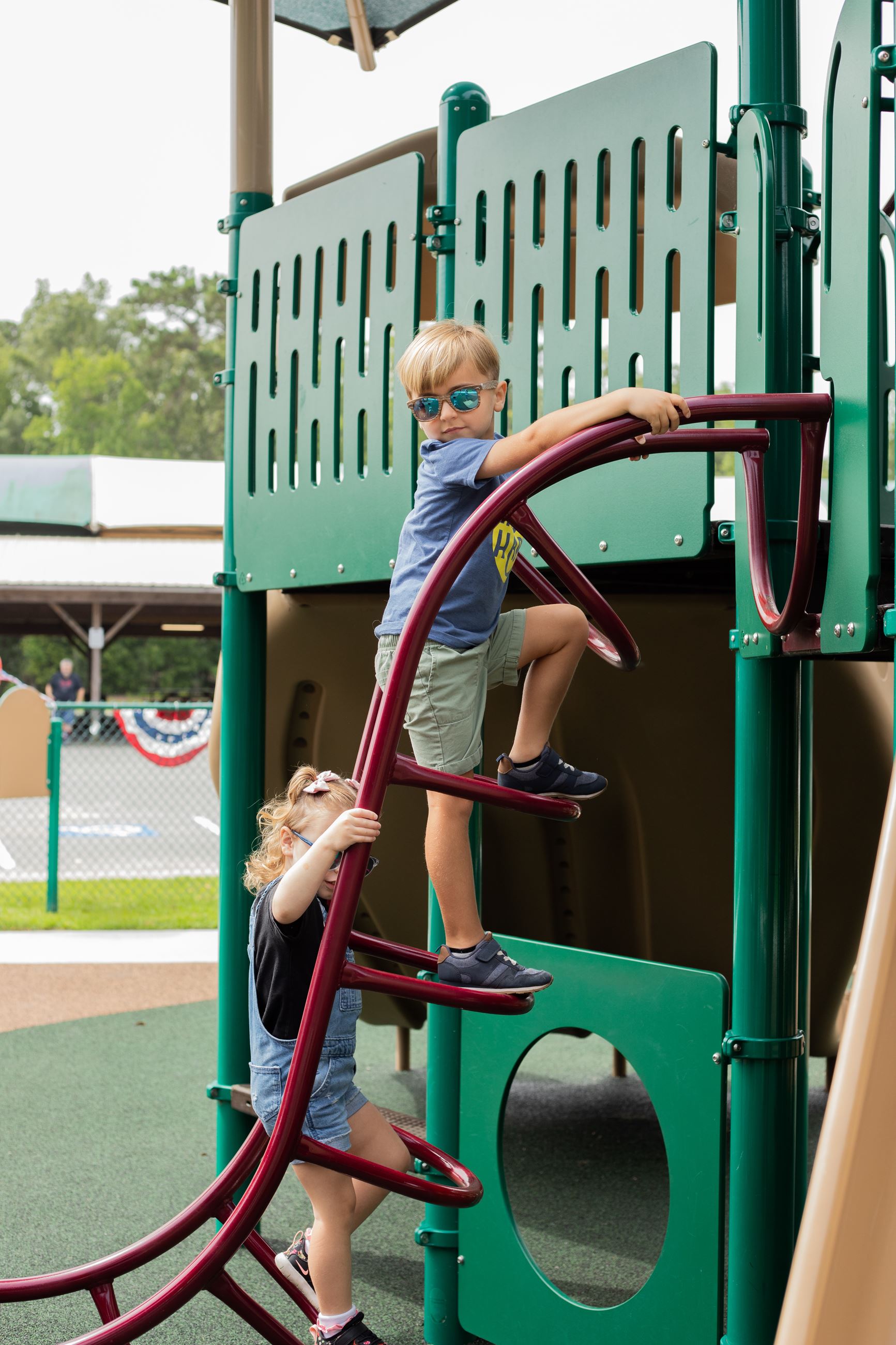two children playing on playground equipment
