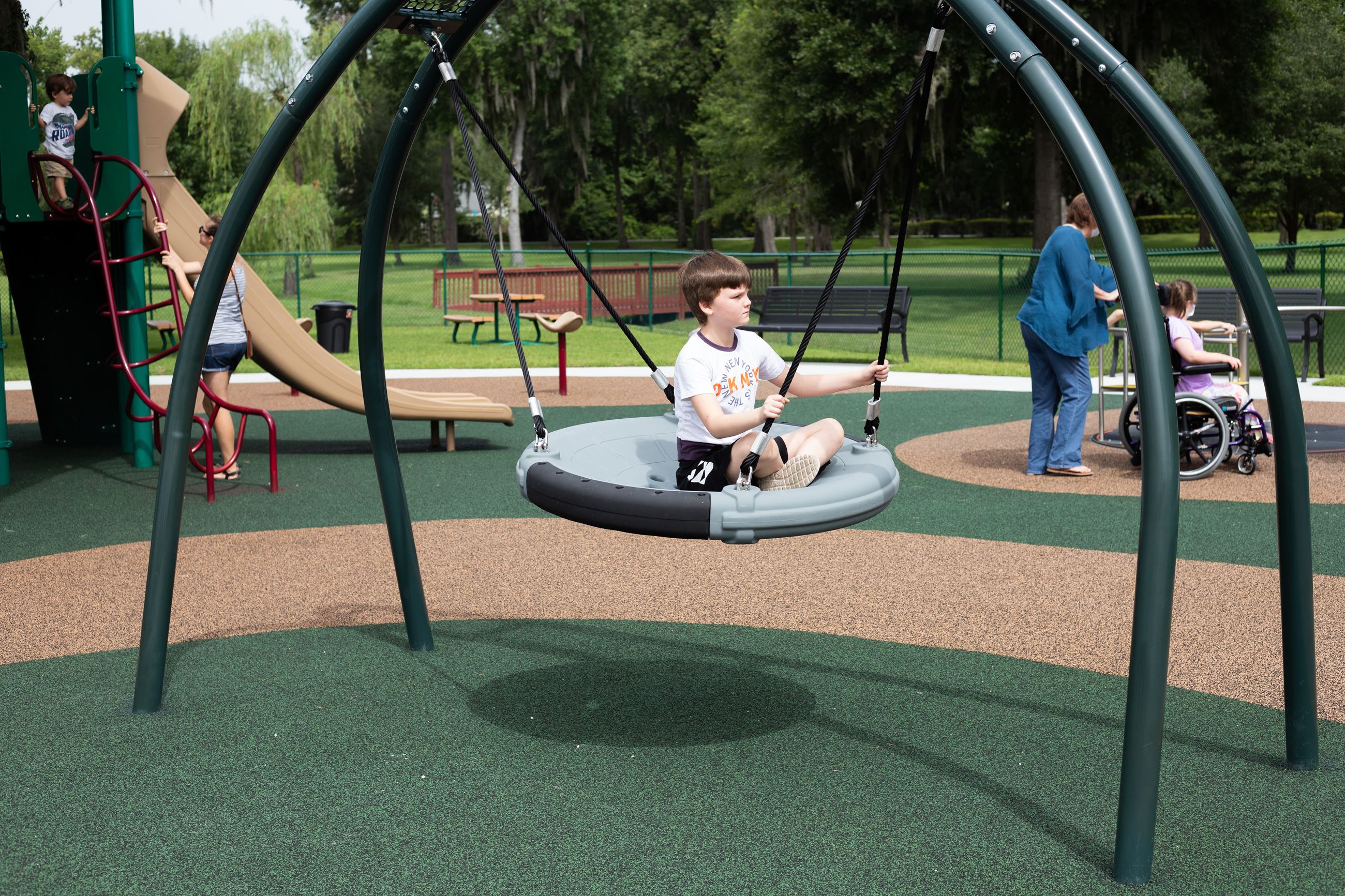 girl swinging on playground swing